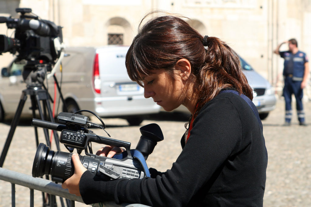 Videojournalist looking at a camera